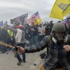 Rioters assault police protecting the U.S. Capitol on Jan. 6, 2021. The Trump administration has systematically tried to rewrite the history of the violent attack, including by purging information from government websites.