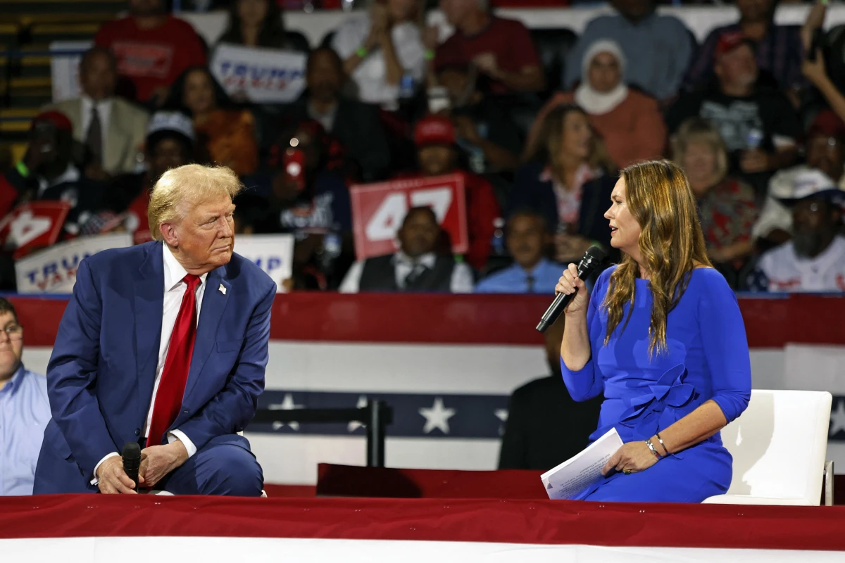Former President Trump attends a town hall meeting moderated by Arkansas Gov. Sarah Huckabee Sanders at the Dort Financial Center in Flint, Mich., on Tues.