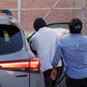 Immigration and Customs Enforcement officer Christian Castro gets into a car surrounded by news reporters moments after being released from a county detention center in Brownsville, Texas on Aug. 27, 2026.
