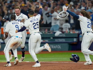 Tampa Bay Rays shortstop Jorge Mateo (9) and right fielder Victor Mesa Jr. (25) celebrate with Tampa Bay Rays second baseman Ben Williamson after his walk-off RBI single during the 12th inning of Game 4 of baseball's World Series, Wednesday, Oct. 28, 2026, in St. Petersburg, Fla., between the Milwaukee Brewers and the Tampa Bay Rays.