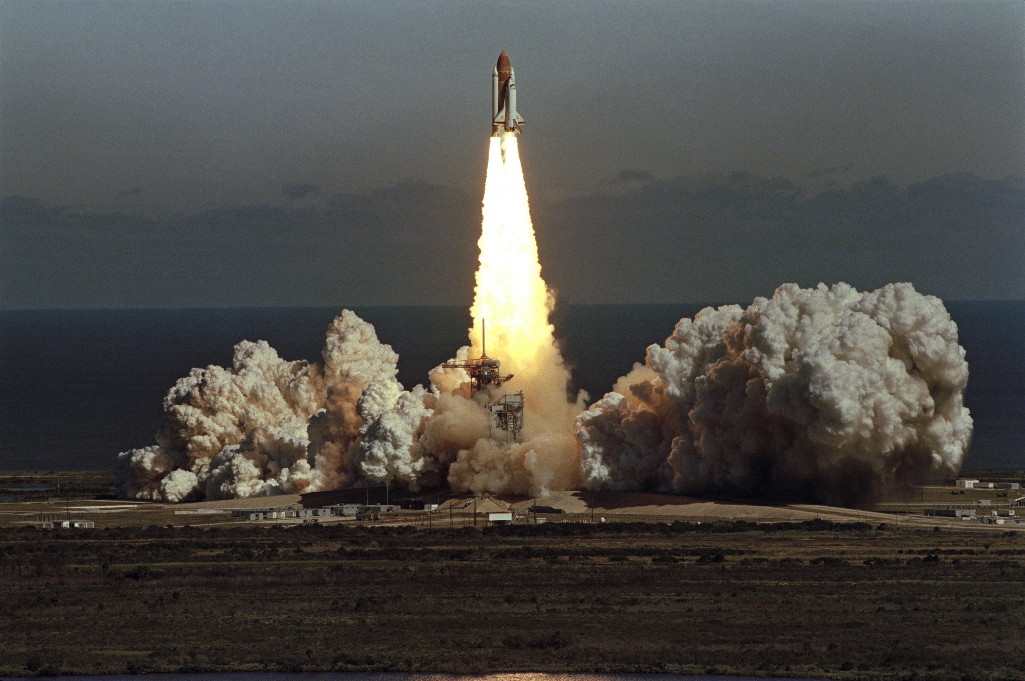 The space shuttle Challenger lifts off from Kennedy Space Center in Florida on Jan. 28, 1986, in a cloud of smoke with a crew of seven aboard. The shuttle exploded shortly after this photo. (AP)