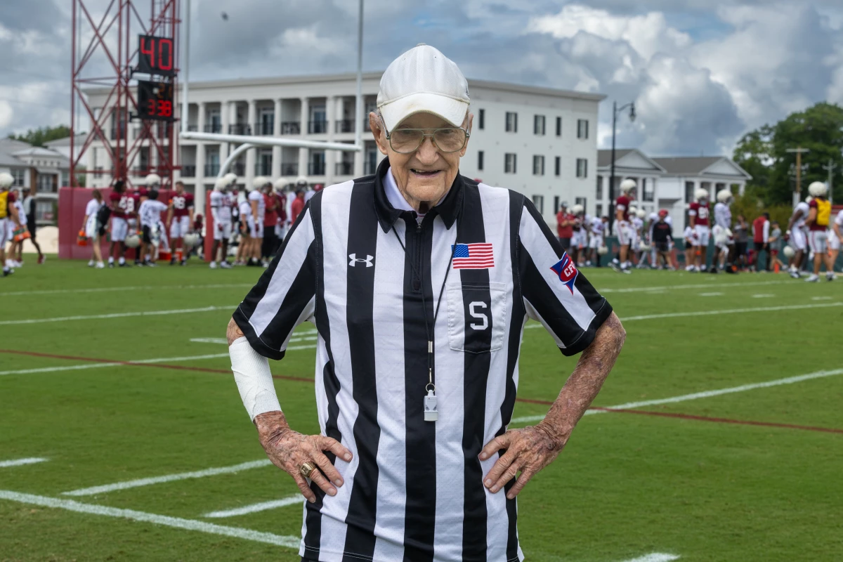 Eddie Conyers stands for a portrait on the University of Alabama football practice field in Tuscaloosa, Ala. Conyers, 97, was a referee for the team during practices for more than 60 years.