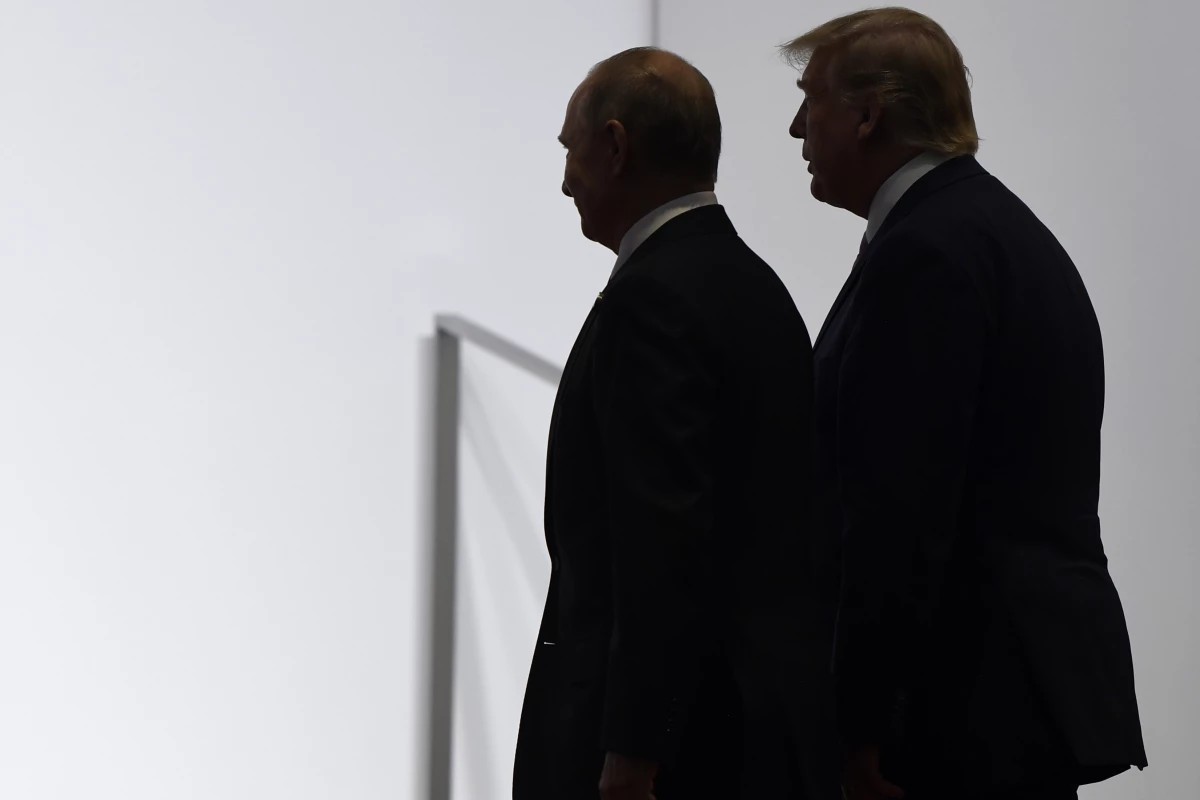 President Donald Trump and Russian President Vladimir Putin walk together at the G20 summit in Osaka, Japan, on June 28, 2019.