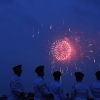 Members of the U.S. Army Band "Pershing's Own" watch fireworks at the end of a military parade commemorating the Army's 250th anniversary on Saturday in Washington, D.C.