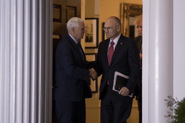 Just weeks after the 2016 election, Andrew Puzder shakes hands with then-Vice President-elect Mike Pence after a meeting with President-elect Trump at his golf club in New Jersey.