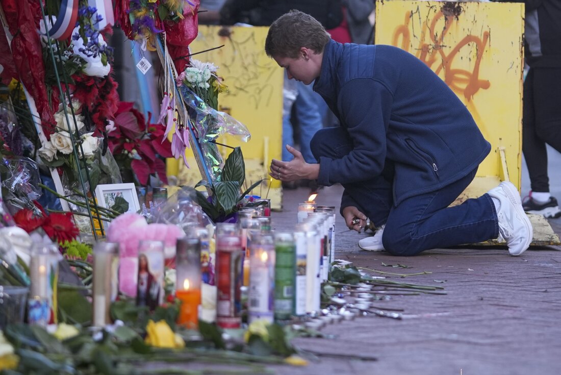 Nathan Williams, a University of New Orleans student, lights a candle at memorial on Bourbon Street for the victims of a deadly truck attack on New Year's Day in New Orleans, Friday, Jan. 3, 2025. (AP Photo/Gerald Herbert)