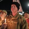 Staff Sgt. Jason Mitchell, a member of the West Virginia Air National Guard, attends a candlelight vigil for Staff Sgt. Andrew Wolfe outside the Berkeley County Sheriff's office on Wednesday in Martinsburg, W.Va.