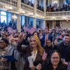 New U.S. citizens, holding up American flags and standing in rows, take part in a naturalization ceremony at Faneuil Hall in Boston on January 8.