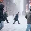 People cross the street in Times Square during a snowstorm on Jan. 25, 2026 in New York City.