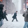 People cross the street in Times Square during a snowstorm on Jan. 25, 2026 in New York City.