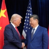 President Donald Trump and Chinese President Xi Jinping, right, shake hands before their meeting at Gimhae International Airport in Busan, South Korea.