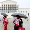 Demonstrators holding signs in support of minority voting rights stand outside the U.S. Supreme Court in Washington, D.C., in March.