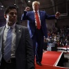 Trump returns to rally crowd in Butler, Pa., site of July assassination attempt 4 Surrounded by U.S. Secret Service agents, former President Donald Trump dances his way offstage. Wearing a blue suit and red tie, he's moving his arms, while Secret Service agents in suits stand in front of him and to his side.