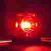 A picture of a red siren light in close up.