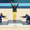 Gymnast Rebeca Andrade (center) of Brazil wins her first gold medal in Paris. Paying homage are silver medalist Simone Biles (left) and bronze medalist Jordan Chiles of the United States.