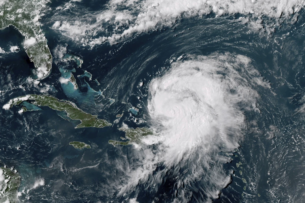 This GOES-16 GeoColor satellite image taken at 4 p.m EDT and provided by National Oceanic and Atmospheric Administration (NOAA) shows Hurricane Ernesto northwest of San Juan, Puerto Rico and moving over open waters, Wednesday, Aug. 14, 2024.
