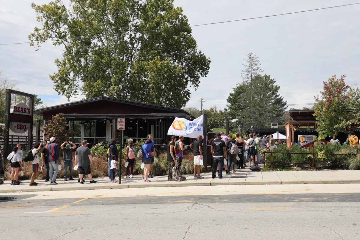 People in Asheville, N.C., line up for a meal outside Bear's Smokehouse BBQ on Monday.