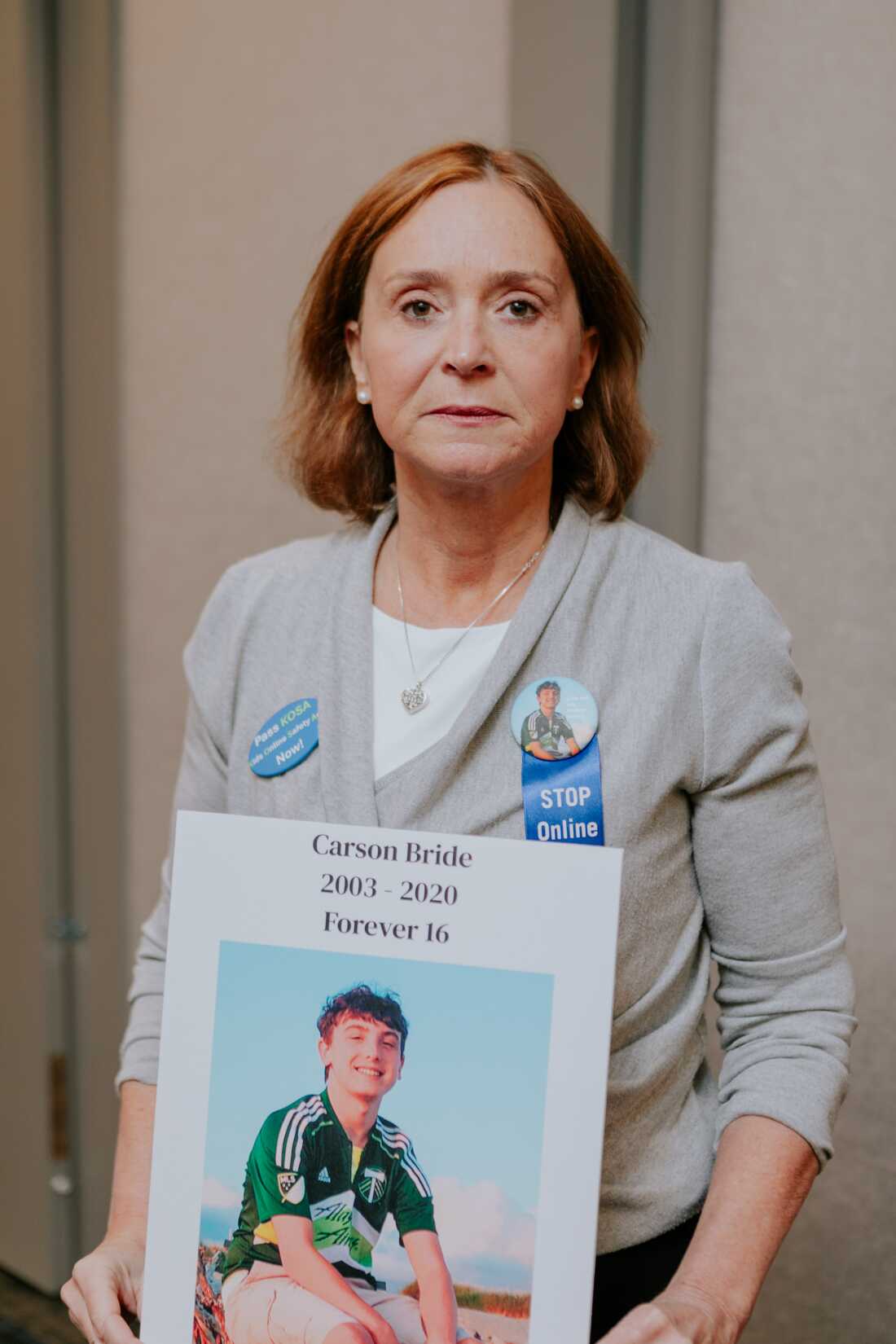 Kristin Bride holds a photo of her 16-year-old son, Carson, who died by suicide in 2020.