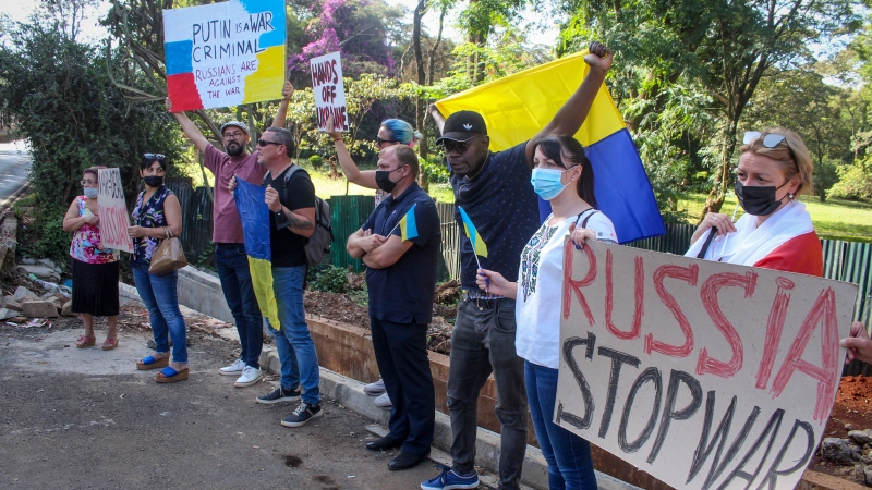 Protesters hold placards at a small demonstration held by Ukrainians, Russians and Kenyans against Russia's invasion of Ukraine, in front of the Russian Embassy in Nairobi, Kenya, on Feb. 26, 2022.