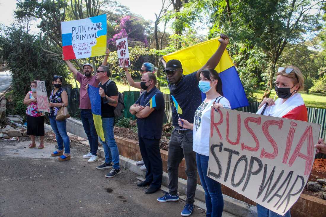 Protesters hold placards at a small demonstration held by Ukrainians, Russians and Kenyans against Russia's invasion of Ukraine, in front of the Russian Embassy in Nairobi, Kenya, on Feb. 26, 2022.