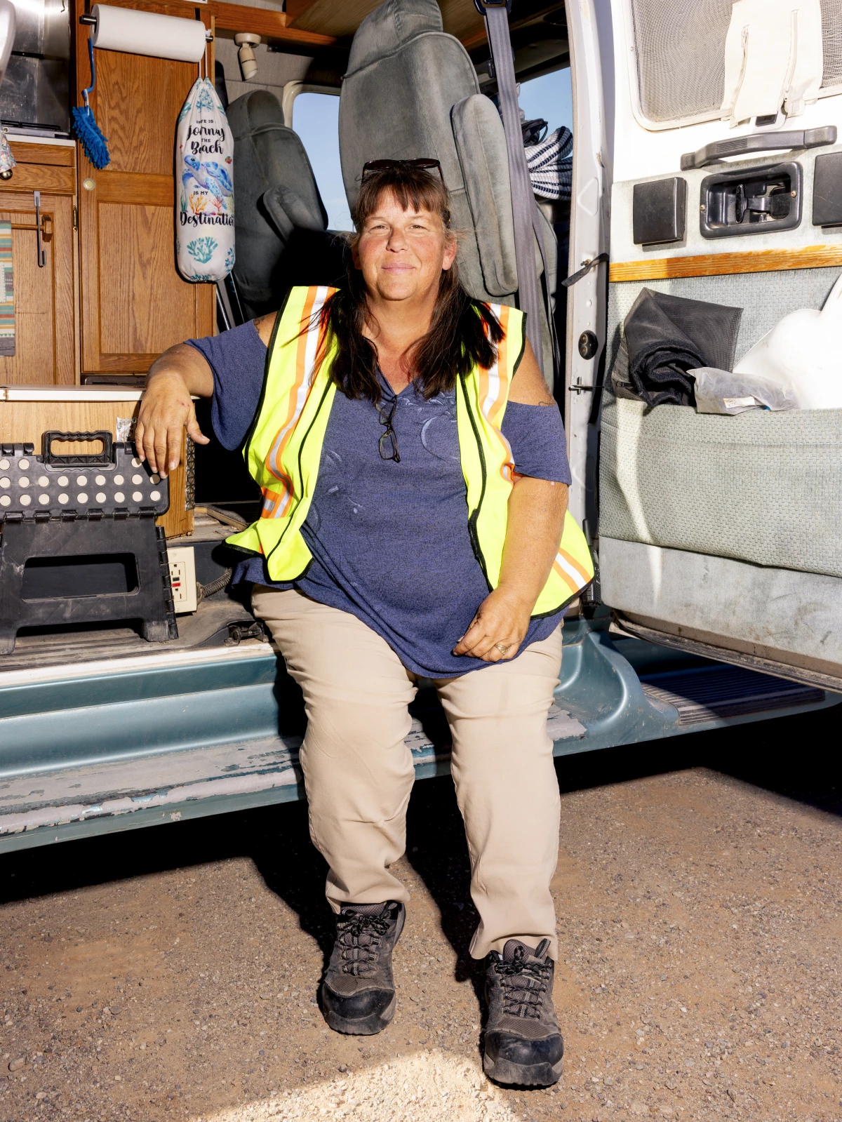 Home on Wheels Alliance staff member Tracey Power sits on the edge of her van.