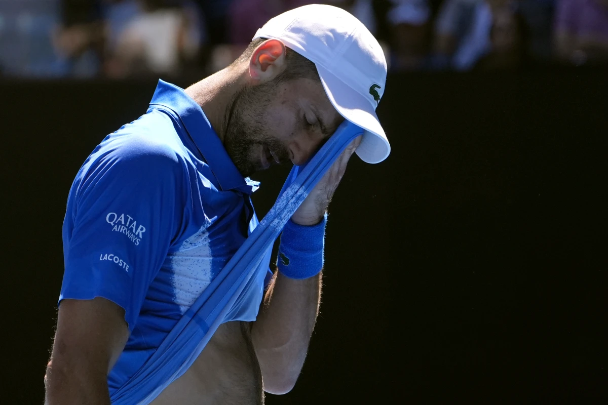 Novak Djokovic of Serbia wipes the sweat from his face during his semifinal match against Alexander Zverev of Germany at the Australian Open tennis championship in Melbourne, Australia, on Friday.