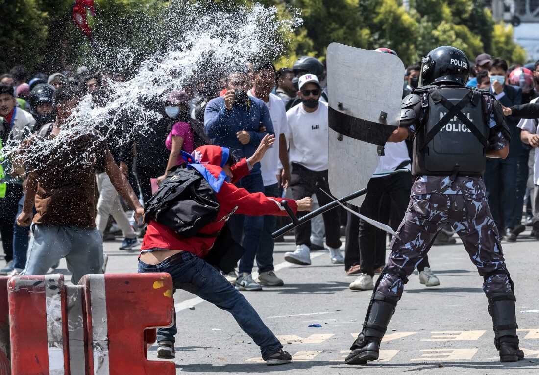 Demonstrators clash with riot police personnel during a protest outside the Parliament in Kathmandu on Monday.