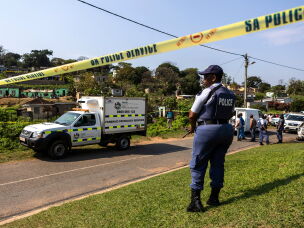 A police officer is seen at a scene of a mass shooting at a house party in KwaMakhutha township south of the city Durban, South Africa, Wednesday, Sept. 23, 2026.