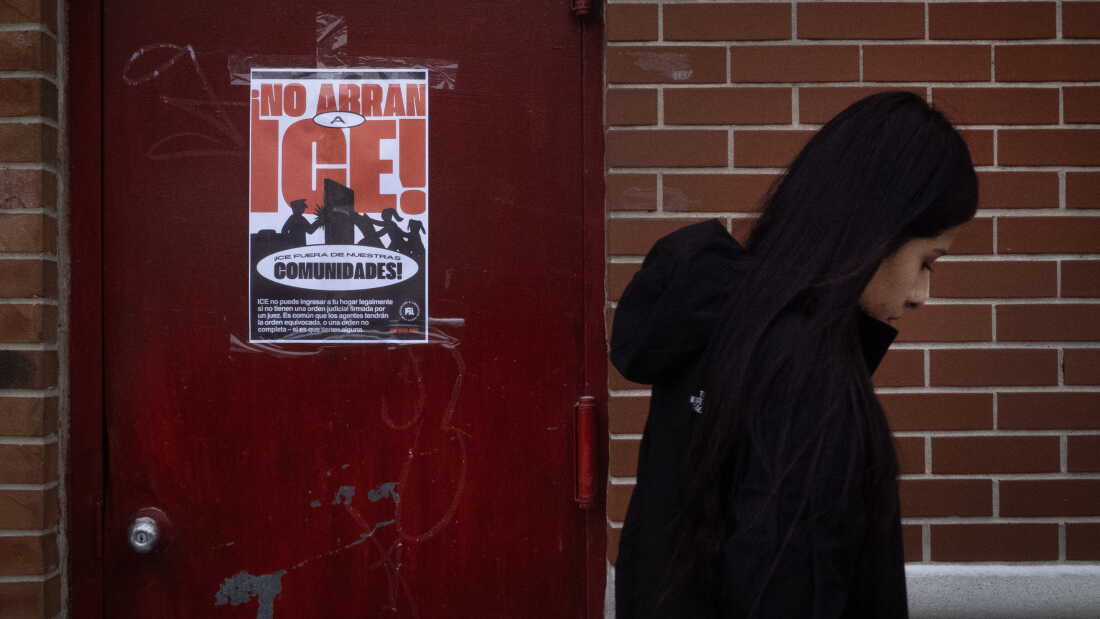 A poster calling on U.S. Immigration and Customs Enforcement (ICE) to get out of the community hangs on a door in the Little Village neighborhood on January 22, 2025 in Chicago, Illinois.