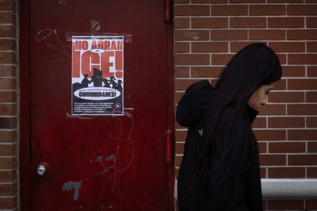 A poster calling on U.S. Immigration and Customs Enforcement (ICE) to get out of the community hangs on a door in the Little Village neighborhood on January 22, 2025 in Chicago, Illinois.