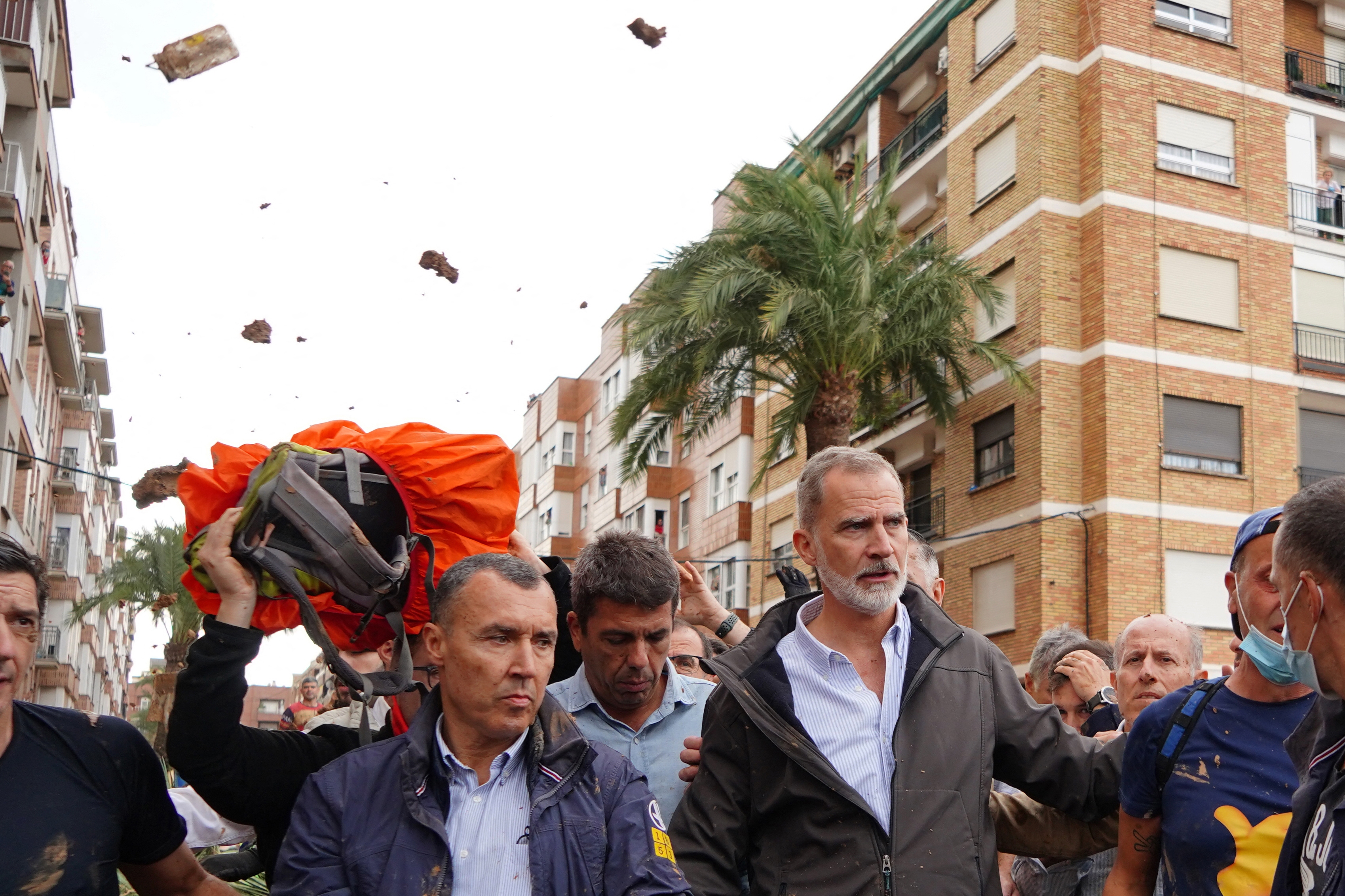King Felipe VI of Spain is heckled by angry residents who throw mud and objects during his visit to Paiporta, in the region of Valencia, eastern Spain, on November 3, 2024, in the aftermath of devastating deadly floods.