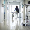 A woman and toddler are shown in a hospital corridor.