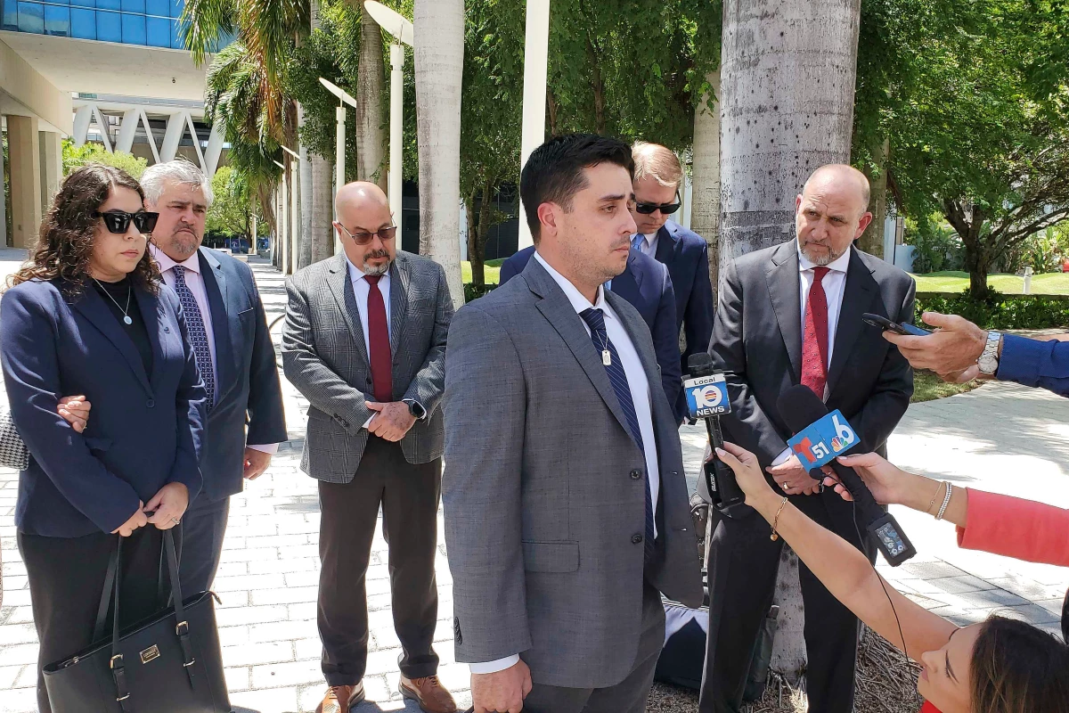 Dillon Angulo, who was seriously injured in a Florida crash involving Tesla's Autopilot driver assist technology, speaks to reporters outside the federal courthouse in Miami on Friday.