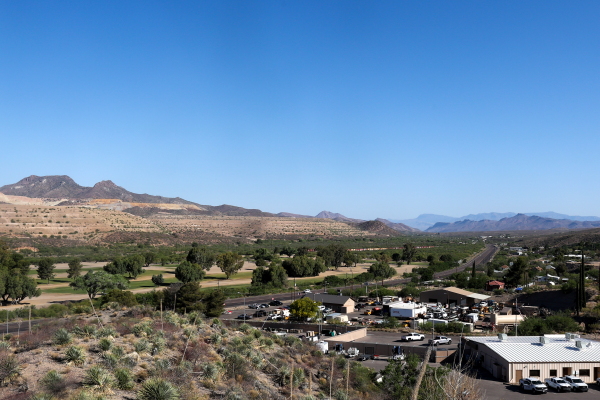 Mountains of mine tailings, or waste, above the valley where Globe, Arizona, is located. The the vista is photographed from above. 