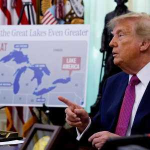 A map labeling Lake Ontario as "Lake America" is displayed as U.S. President Donald Trump takes a question from a reporter after signing an executive order during an event in the Oval Office.