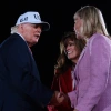 North Carolina Republican Congressional candidates, state Rep. Jennifer Balkcom and Laurie Buckhout (right), are embraced by President Trump during an election rally on Oct. 20, 2026, in Greenville, N.C. Buckhout is running in North Carolina's 1st District, which was redrawn to heavily favor Republicans and is now a toss-up.