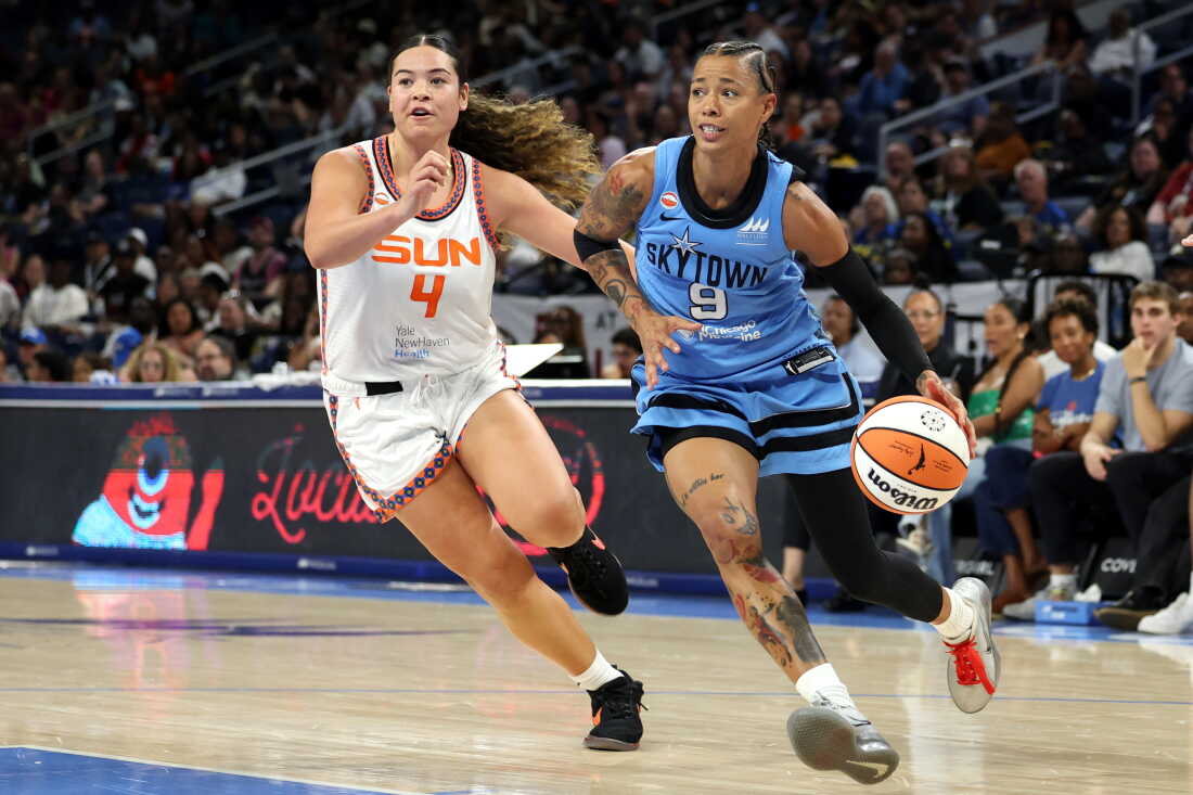 Natasha Cloud #9 of the Chicago Sky dribbles past Charlisse Leger-Walker #4 of the Connecticut Sun during the first half at Wintrust Arena on July 30 in Chicago.