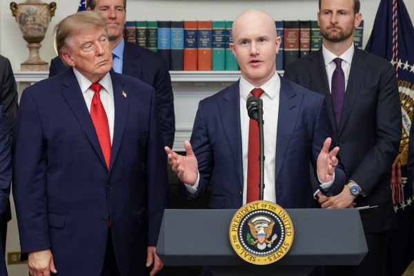 Brian Armstrong, the CEO of major crypto company Coinbase, speaks as President Trump looks on during a summit of crypto and technology leaders at the White House in Washington, D.C., on Aug. 19, 2026.