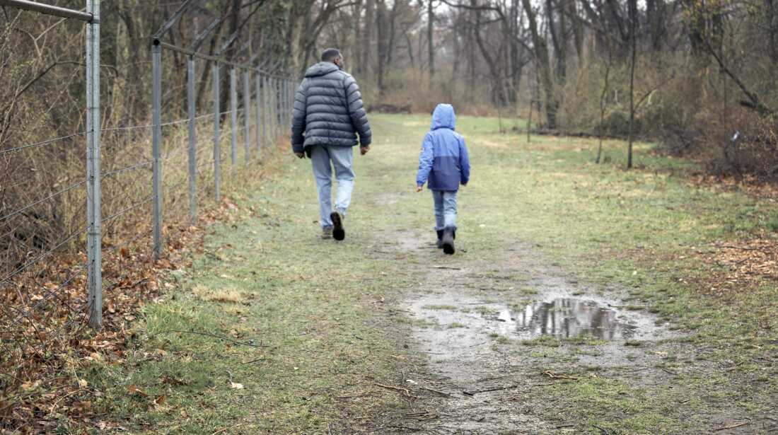 Russel and Khalib hike along the nature trail on a chilly, wet spring day. They both were excited about the weather, because the birds would be more active.