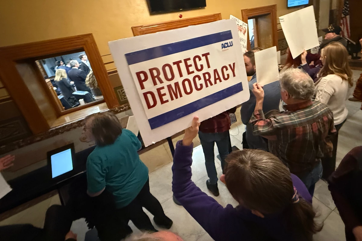 Protesters gather outside the Senate chamber at the Indiana statehouse in Indianapolis as senators meet during a special session to vote on a new congressional map on Dec. 8, 2025.