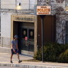 A person walks by the Ithaca Police Department headquarters on March 22, 2021, in Ithaca, N.Y.
