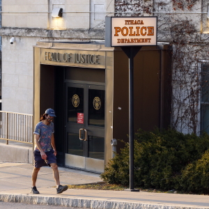A person walks by the Ithaca Police Department headquarters on March 22, 2021, in Ithaca, N.Y.