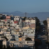 Should states force cities to build cheaper houses? Voters here will decide 17 This photo taken at a distance shows houses and buildings in San Francisco's North Beach neighborhood. The structures are mainly various pastel colors such as pink, light blue and butter yellow. Mountains rise in the background.