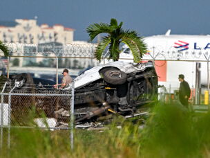 Officials investigate the scene where cars were damaged after a Prime Air cargo plane overran the runway and struck vehicles at Miami International Airport in Miami on Sept. 6, 2026.