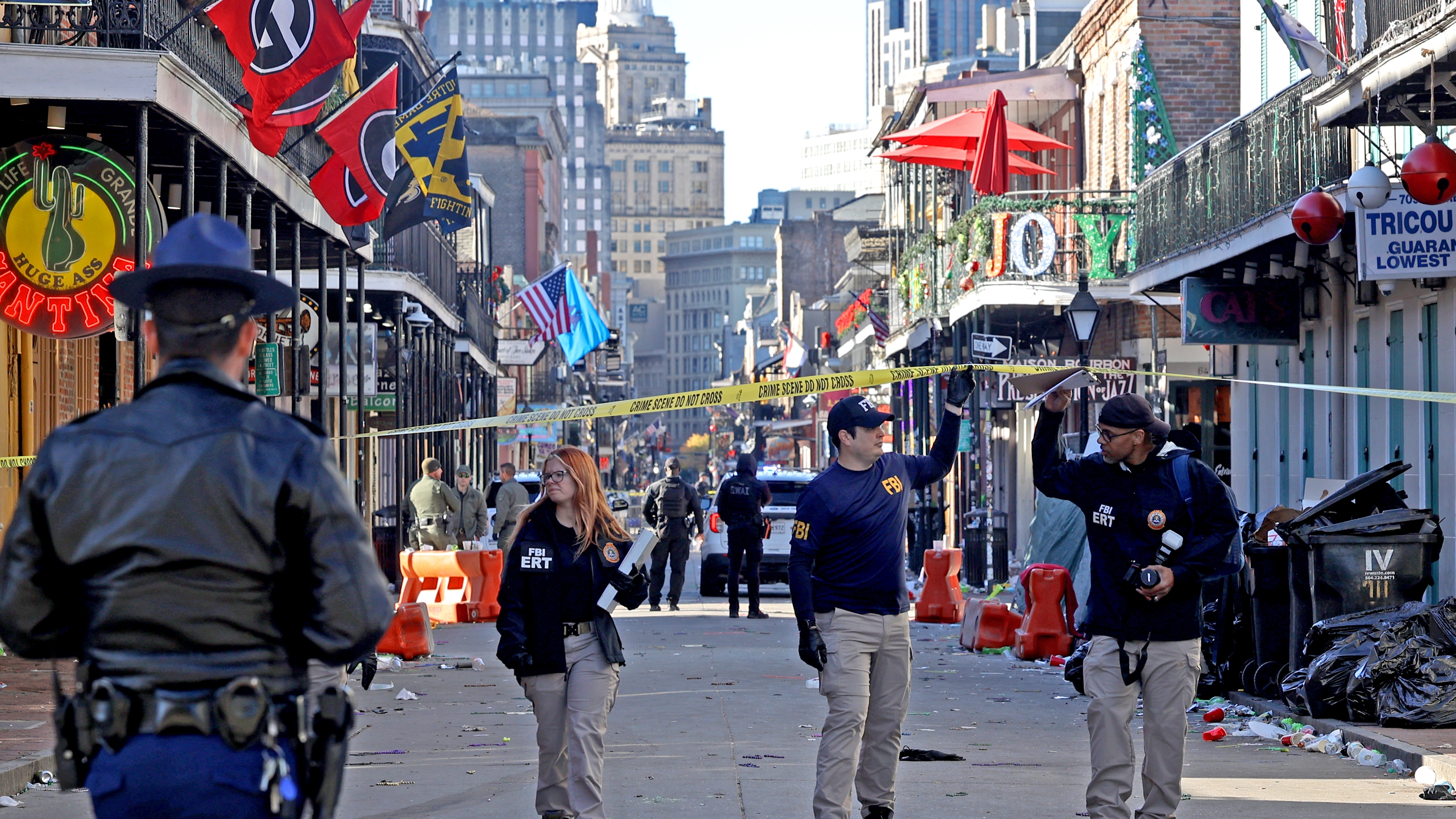 Law enforcement officers from multiple agencies work the scene on Bourbon Street after a person drove a truck into the crowd.