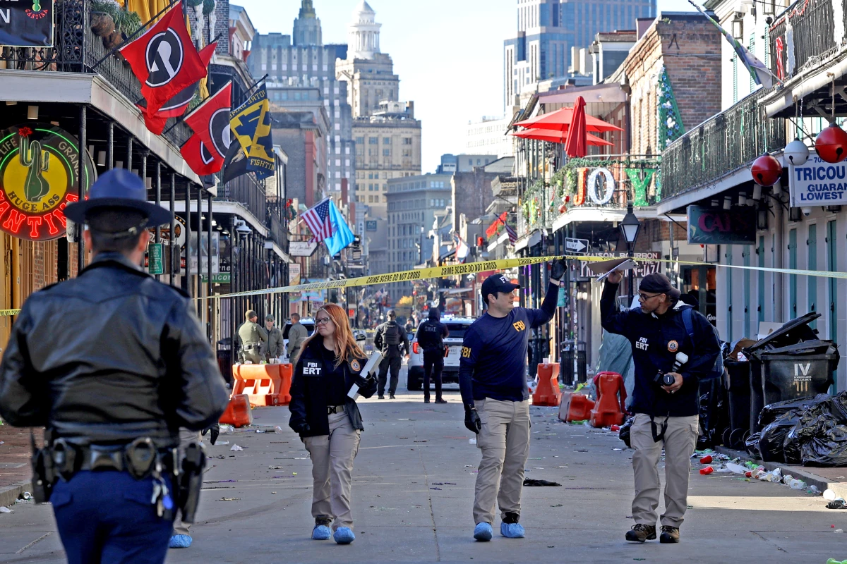 Law enforcement officers from multiple agencies work the scene on Bourbon Street after at least ten people were killed when a person allegedly drove into the crowd.