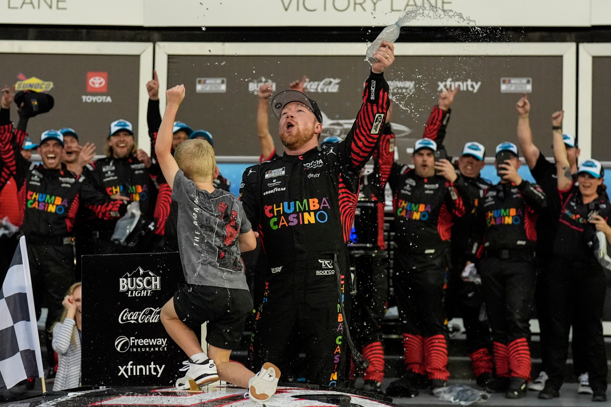 Tyler Reddick, (45) and his son Beau celebrate with the team after winning the NASCAR Daytona 500 auto race at Daytona International Speedway, Sunday, Feb. 15, 2026, in Daytona Beach, Fla.