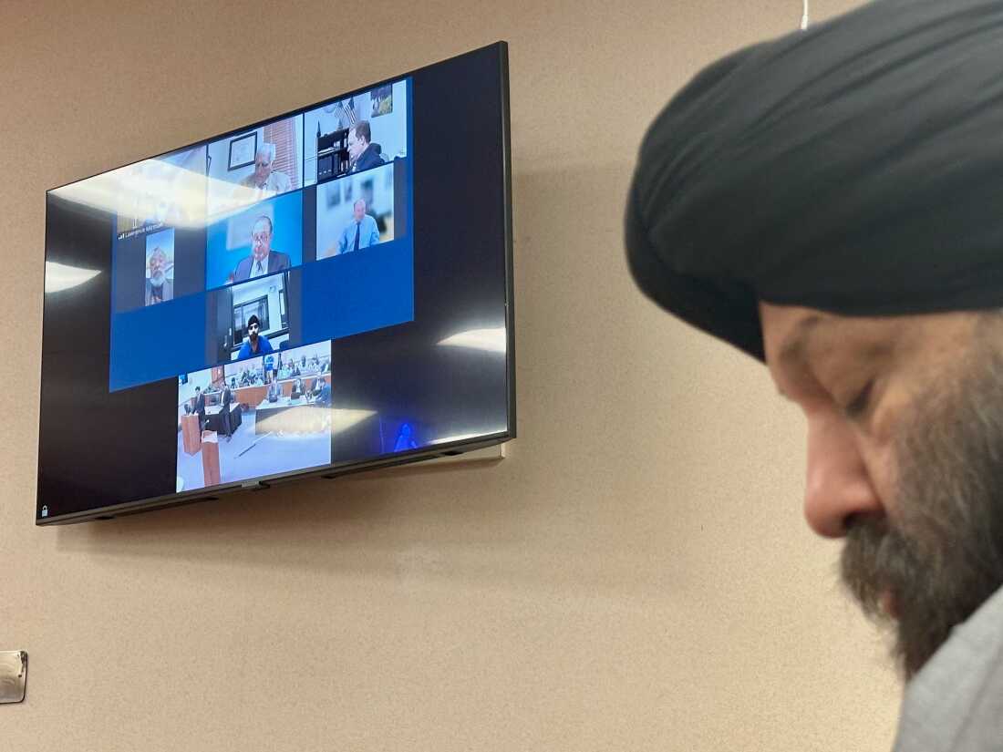 Harjinder Singh is seen on a video screen next to his attorney Tejinder Bains during court proceedings in Fort Pierce, Fla. on Thursday, Nov. 13, 2025.