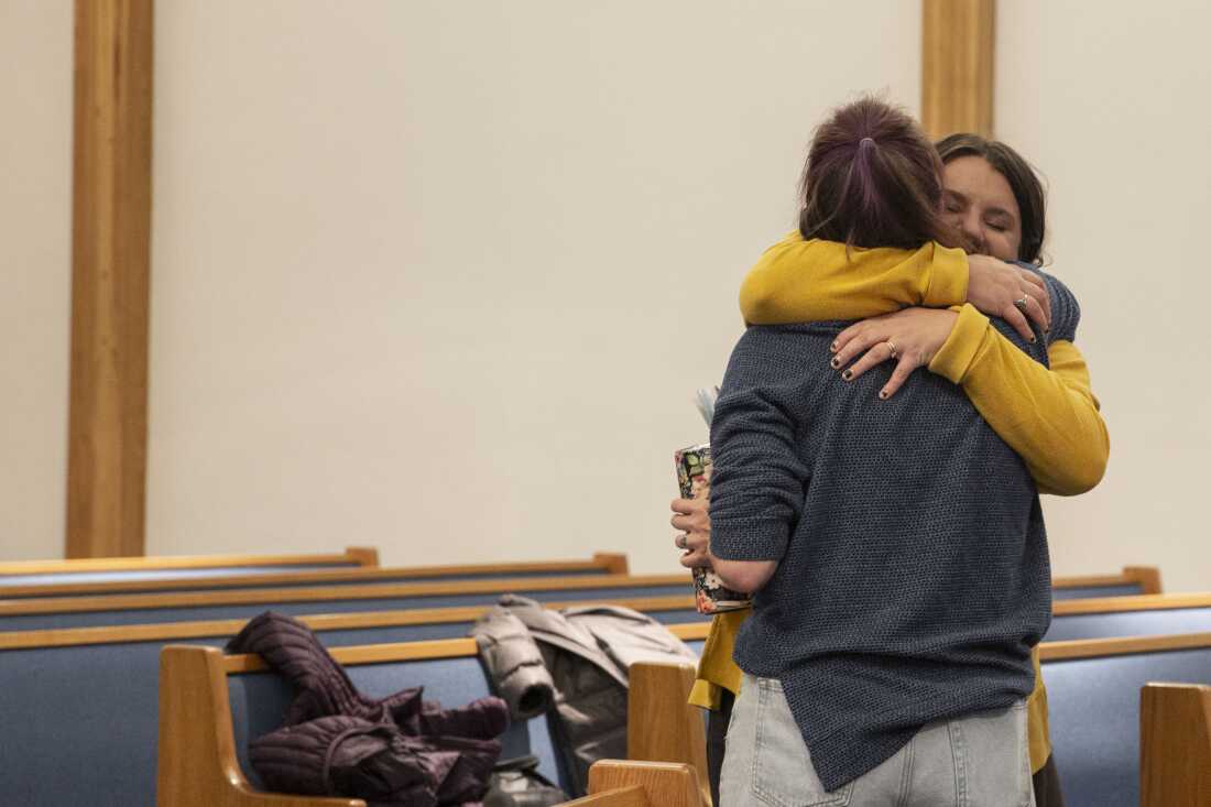 Choir members hug at practice the day after Election Day.