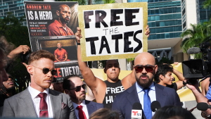Andrew and Tristan Tate are fighting extradition to the U.K. on charges of rape and human trafficking. Here, their attorney Joe McBride, right, speaks to journalists before an Aug. 27 bond hearing at the C. Clyde Atkins U.S. Courthouse in Miami.